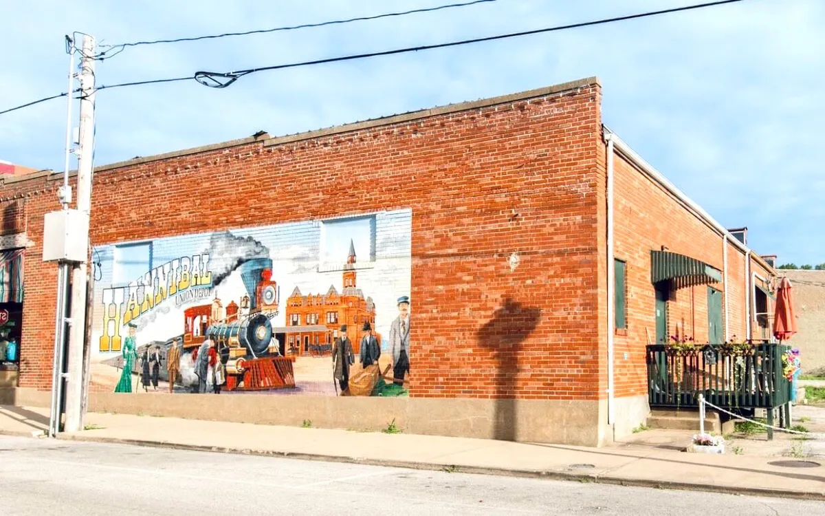 A striking mural of a steam train and historical figures in period clothing, painted on a brick wall. This exterior shot evokes the town's rich history and playful spirit, often celebrated during local festivals and public gatherings.